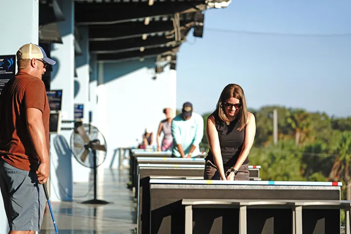 People playing in the hitting bays at Sailfish Sands