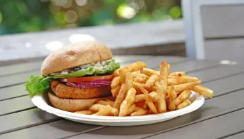 Image of a fried chicken sandwich with a side of fries