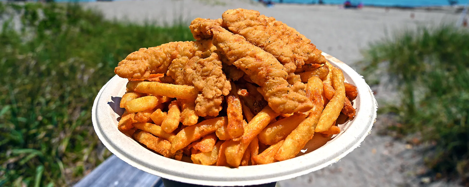 Chicken tenders on top of French fries at Jensen Beach