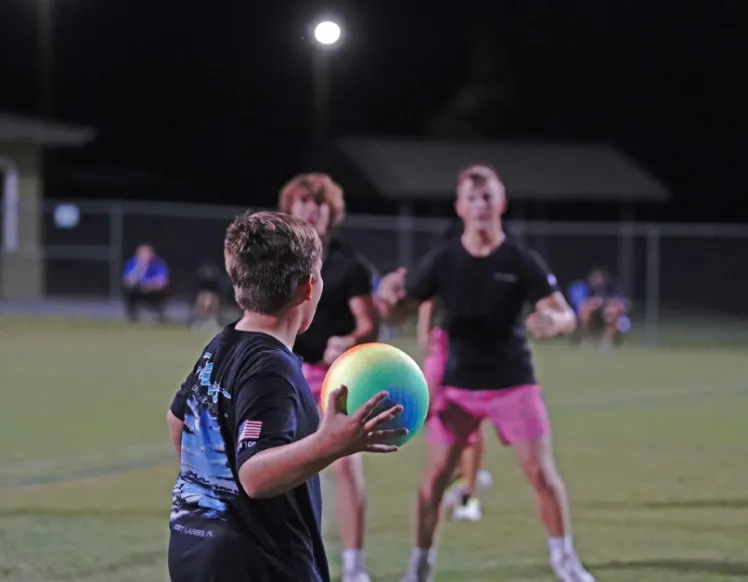 Teens playing dodgeball